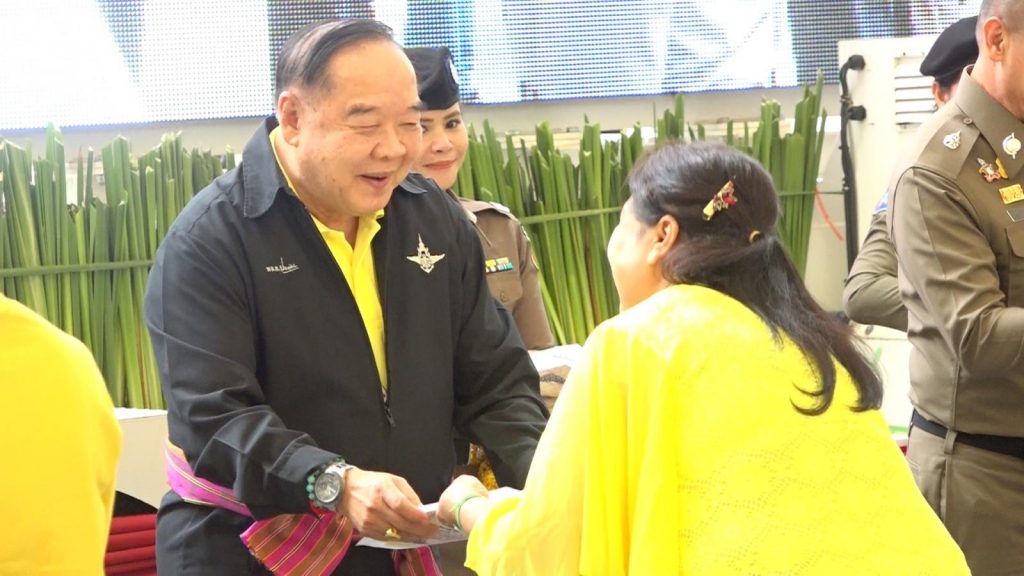 Thailand loan sharks crackdown: Gen. Prawit Wongsuwan pressents title documents to a woman who was a victim of Thai loan sharks after a coordinated crackdwon in Khon Khaen and Udon Thani provinces at the end of June