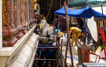 Work on city centre temple halted as red coffin of a female is found buried beneath an image of Buddha