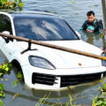 Motorist’s shocked horror after 6 million baht luxury car rolls across a motorway and into a deep irrigation canal